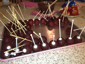 inserting sticks into red velvet nutella-filled cake pops