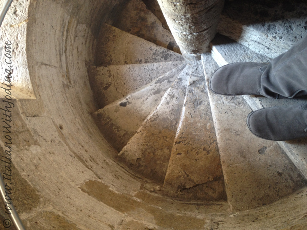 boots going down spiral staircase in Siena