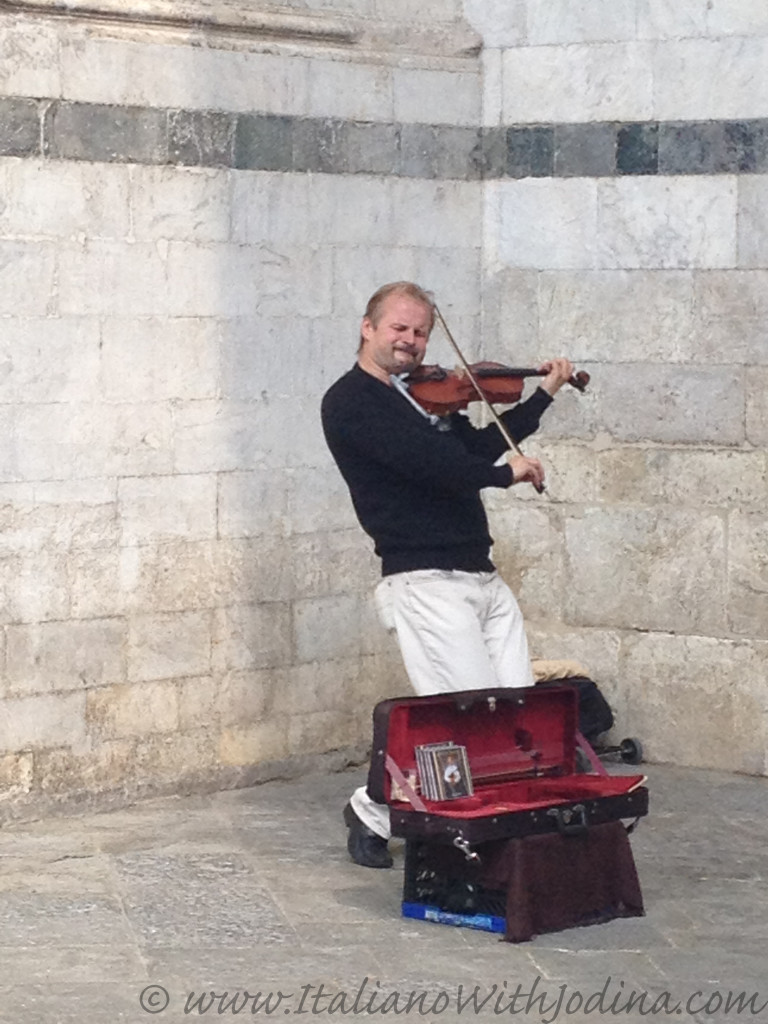 a fiddler in siena italy near piazza del duomo