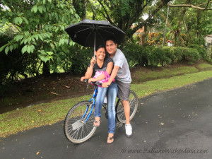 couple on bike with umbrella - wm