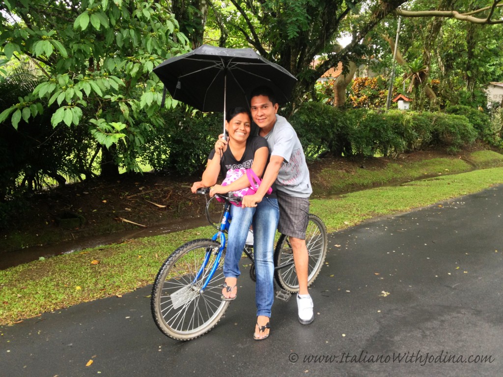 couple on bike with umbrella
